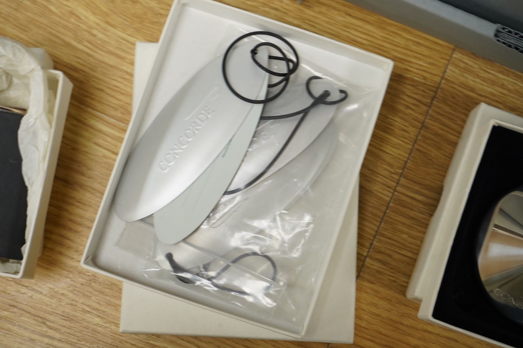 Five boxed British Airways Concorde branded promotional items including; a sterling silver trinket box by Links of London, a hip flask, a bottle opener, a leather credit card holder, and three unused luggage labels